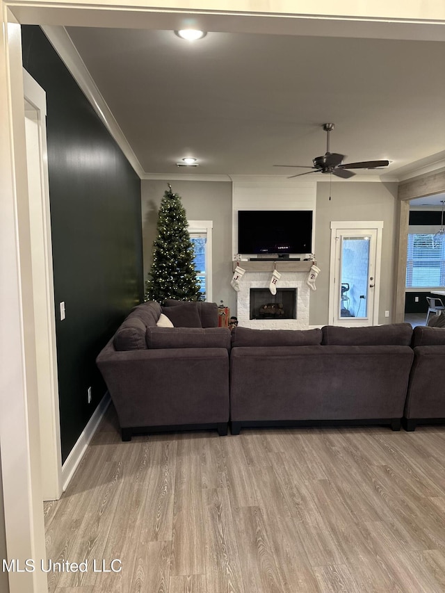 living room featuring crown molding, ceiling fan, and hardwood / wood-style floors