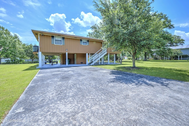 39 Harrison Rd, Bay Saint Louis, MS 39520 - beach home with stairway, a carport, driveway, and a front lawn