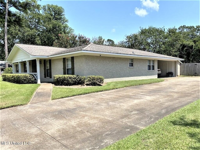 210 Jefferson Davis Blvd, Natchez, MS 39120 - ranch-style home featuring brick siding, concrete driveway, a porch, and a carport