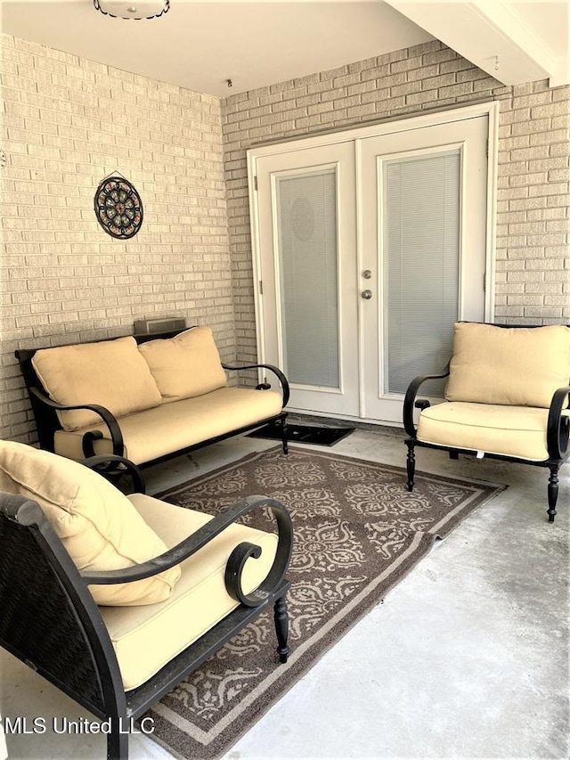 210 Jefferson Davis Blvd, Natchez, MS 39120 - living area with brick wall and concrete floors