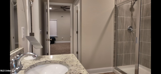 bathroom featuring vanity, ceiling fan, and walk in shower