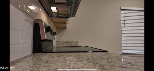 kitchen with stainless steel range and backsplash