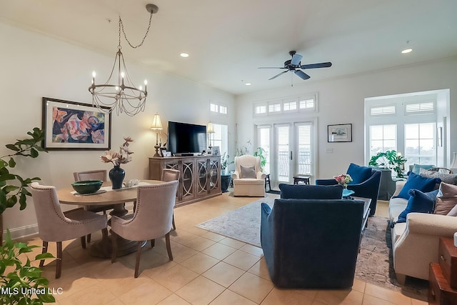 living area featuring ornamental molding, recessed lighting, light tile patterned flooring, and ceiling fan with notable chandelier