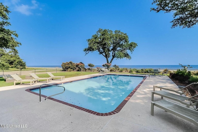 view of pool with a water view, fence, a fenced in pool, and a patio