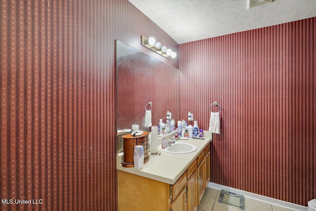 2120 Meagan Dr, Byram, MS 39272 - bathroom with tile patterned floors, vanity, and a textured ceiling