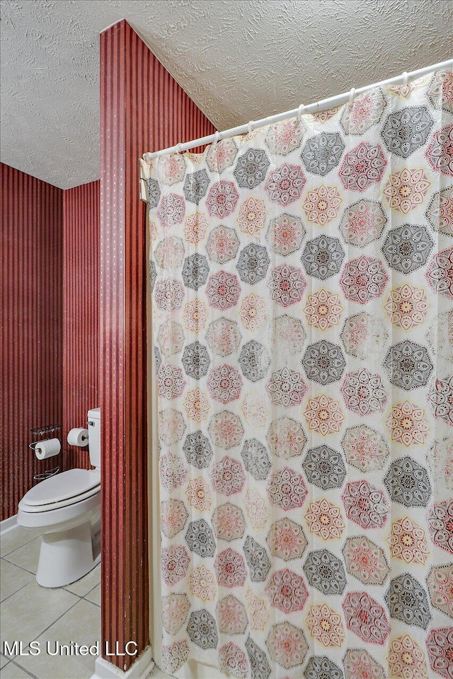 2120 Meagan Dr, Byram, MS 39272 - full bath with a textured ceiling, tile patterned flooring, and curtained shower
