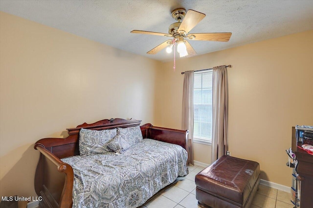 2120 Meagan Dr, Byram, MS 39272 - bedroom with light tile patterned flooring, a textured ceiling, and a ceiling fan