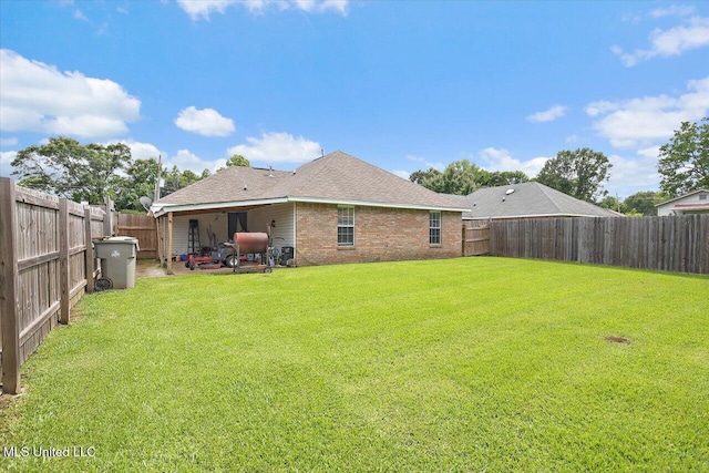 2120 Meagan Dr, Byram, MS 39272 - back of house with a fenced backyard, a shingled roof, and brick siding