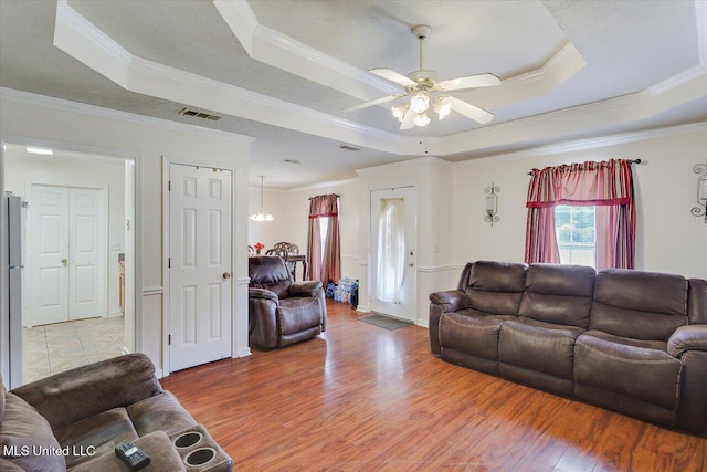 2120 Meagan Dr, Byram, MS 39272 - living area with a tray ceiling, crown molding, ceiling fan, and light wood-style flooring