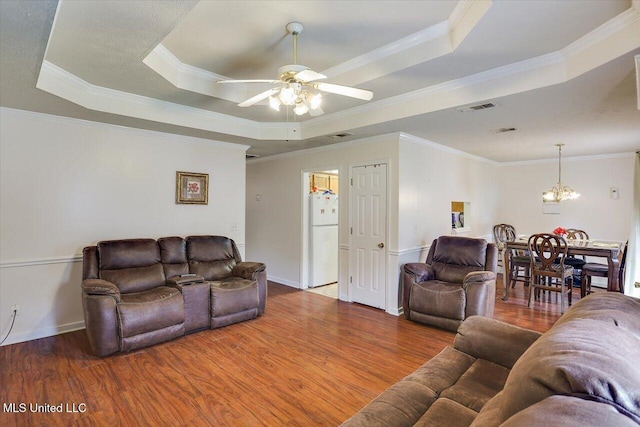 2120 Meagan Dr, Byram, MS 39272 - living room with a tray ceiling, wood finished floors, ceiling fan, ornamental molding, and a chandelier