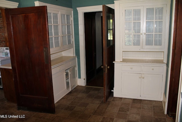 245 E College Ave, Holly Springs, MS 38635 - kitchen featuring light countertops and white cabinetry