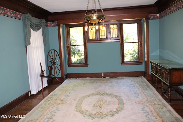 245 E College Ave, Holly Springs, MS 38635 - dining area featuring baseboards, wood finished floors, plenty of natural light, ornamental molding, and decorative columns