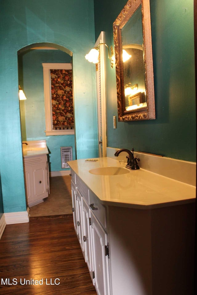 245 E College Ave, Holly Springs, MS 38635 - bathroom with wood finished floors, baseboards, and vanity