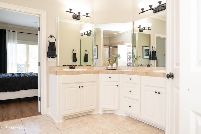 105 Bridgeton Way, Canton, MS 39046 - ensuite bathroom with ornamental molding, tile patterned flooring, double vanity, and a shower stall