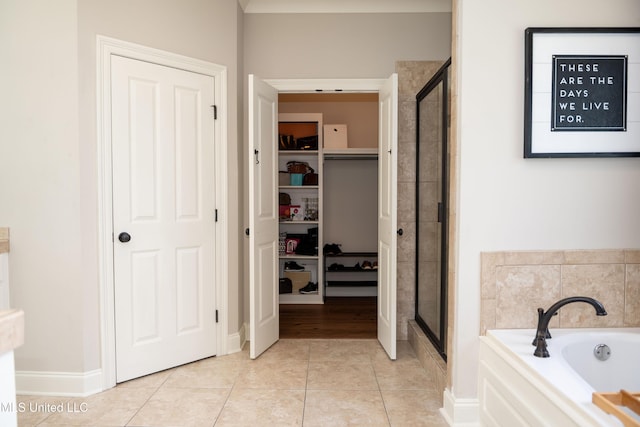105 Bridgeton Way, Canton, MS 39046 - full bathroom featuring a shower stall, a garden tub, a walk in closet, and tile patterned floors
