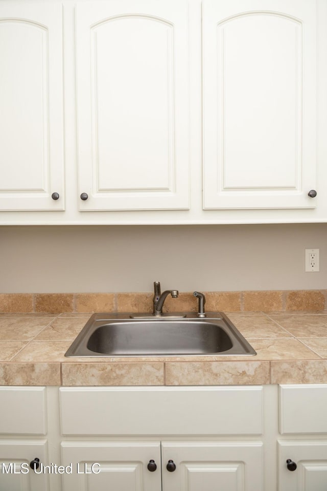 105 Bridgeton Way, Canton, MS 39046 - kitchen featuring tile countertops and white cabinetry