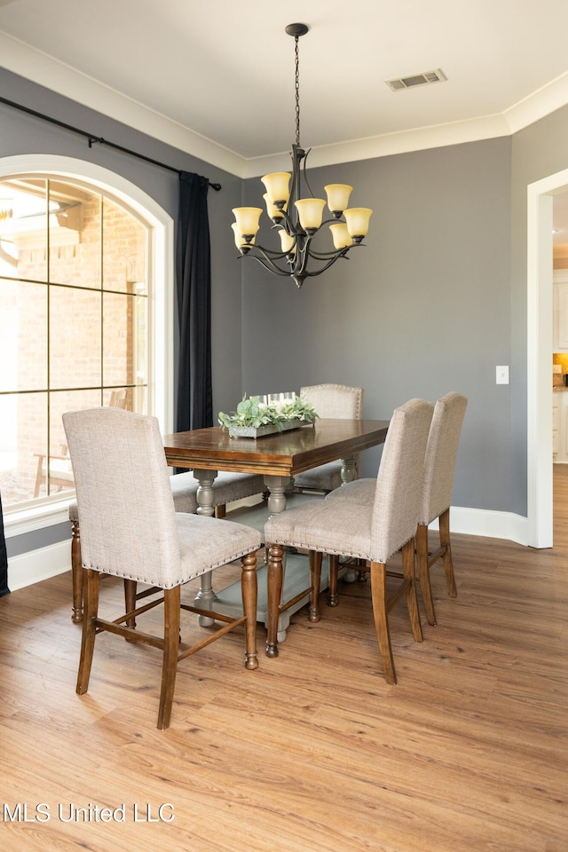 105 Bridgeton Way, Canton, MS 39046 - dining area featuring a chandelier, light wood-style flooring, and ornamental molding