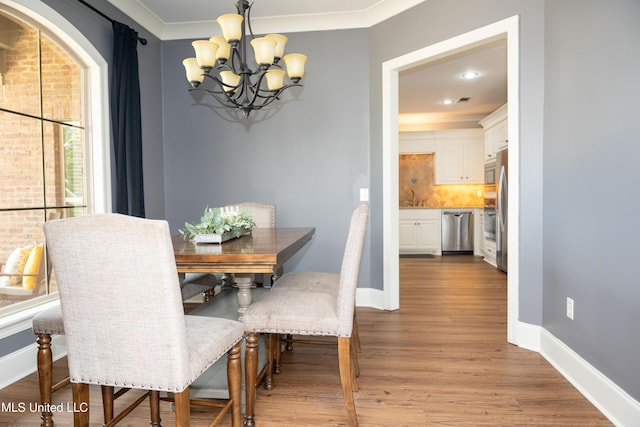 105 Bridgeton Way, Canton, MS 39046 - dining space featuring a chandelier, wood finished floors, and crown molding