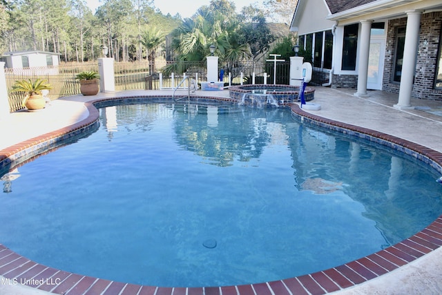 view of swimming pool featuring an in ground hot tub and a patio