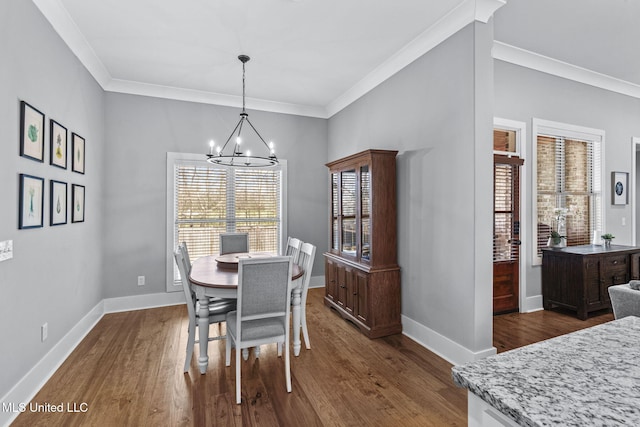 dining room with a chandelier, dark wood finished floors, and baseboards