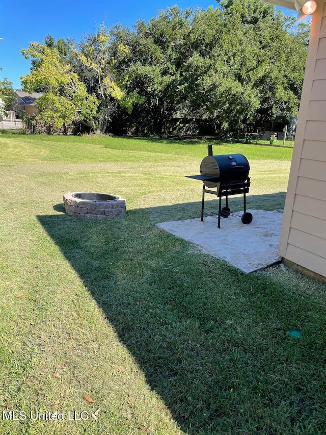 view of yard with an outdoor fire pit and a patio area