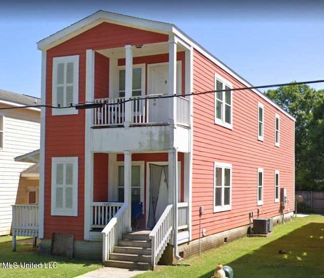 13497 Artes St, Gulfport, MS 39503 - rear view of property featuring covered porch, central AC unit, a balcony, crawl space, and a lawn
