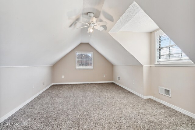 bonus room featuring a wealth of natural light, vaulted ceiling, and carpet floors