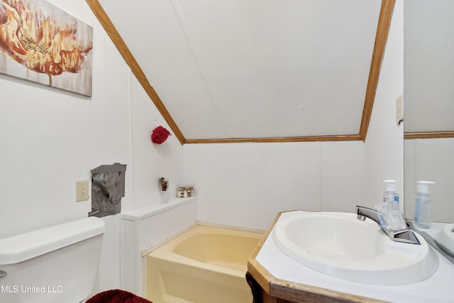 bathroom featuring lofted ceiling, toilet, a washtub, sink, and ornamental molding