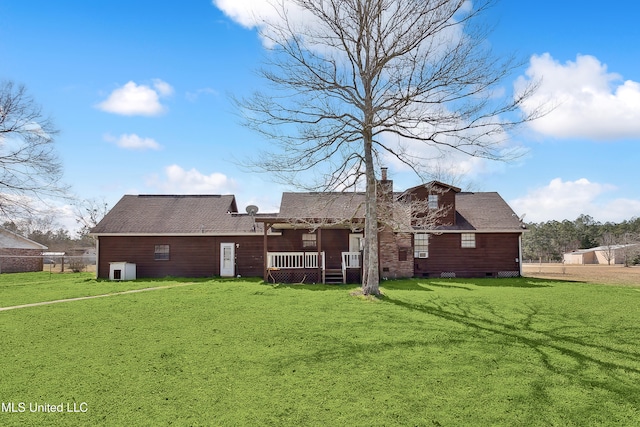 rear view of property with a lawn and a wooden deck