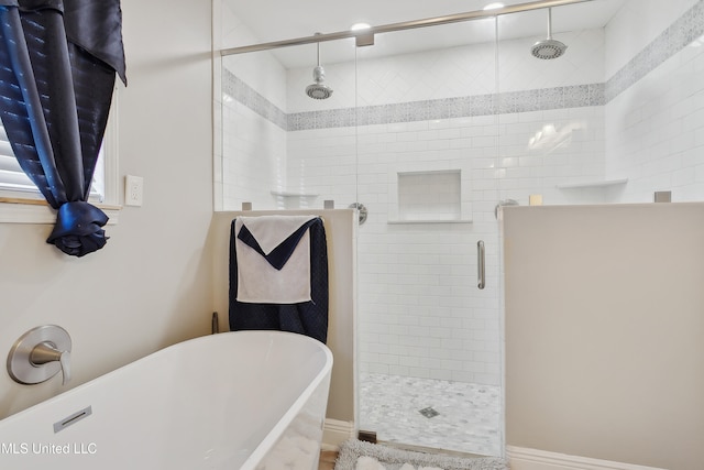 bathroom featuring independent shower and bath