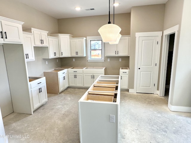 3755 Roland Dr, Southaven, MS 38672 - kitchen with unfinished concrete flooring, white cabinets, decorative light fixtures, and a center island