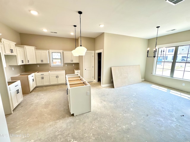 3755 Roland Dr, Southaven, MS 38672 - kitchen with a kitchen island, recessed lighting, a chandelier, unfinished concrete floors, and white cabinetry