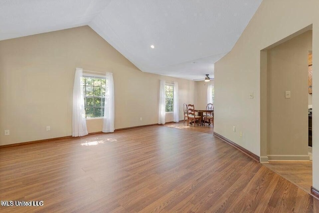 unfurnished room featuring light wood finished floors, baseboards, and a ceiling fan