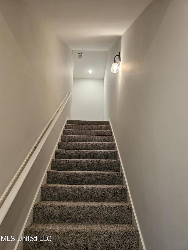 stairway featuring carpet, visible vents, and baseboards