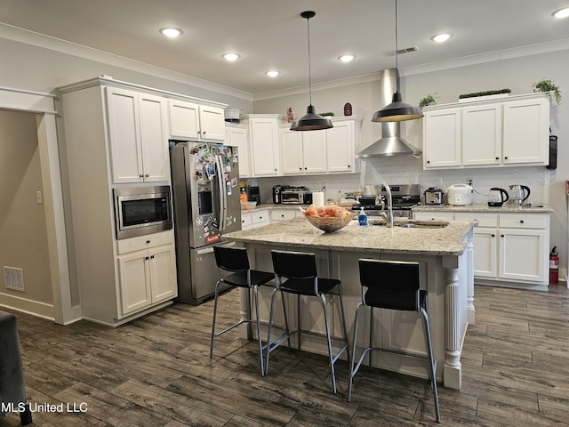 kitchen with appliances with stainless steel finishes, dark wood-type flooring, visible vents, and decorative backsplash