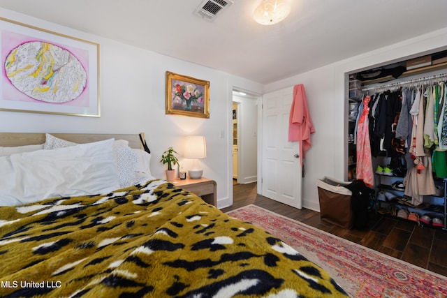 bedroom featuring dark wood-type flooring and a closet