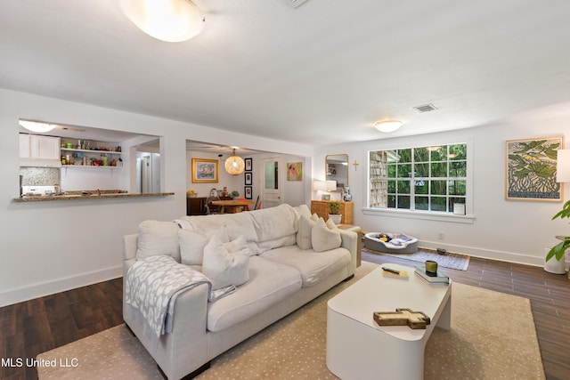 living room with dark hardwood / wood-style flooring