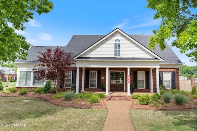 6507 Shenandoah Ln, Olive Branch, MS 38654 - neoclassical home with a shingled roof, brick siding, a porch, a front yard, and french doors