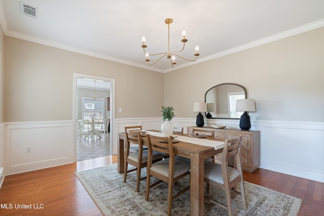 6507 Shenandoah Ln, Olive Branch, MS 38654 - dining space featuring a notable chandelier, ornamental molding, and visible vents