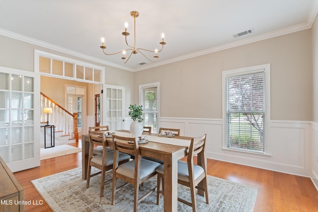 6507 Shenandoah Ln, Olive Branch, MS 38654 - dining room with crown molding, a wainscoted wall, french doors, and a chandelier