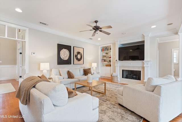 6507 Shenandoah Ln, Olive Branch, MS 38654 - living area featuring crown molding, a ceiling fan, wood finished floors, and visible vents