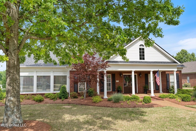 6507 Shenandoah Ln, Olive Branch, MS 38654 - neoclassical home featuring brick siding, covered porch, and a front yard
