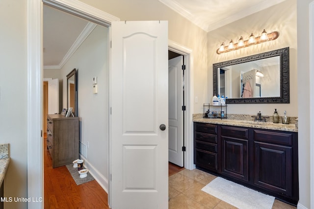 6507 Shenandoah Ln, Olive Branch, MS 38654 - bathroom featuring vanity, ornamental molding, and wood finished floors