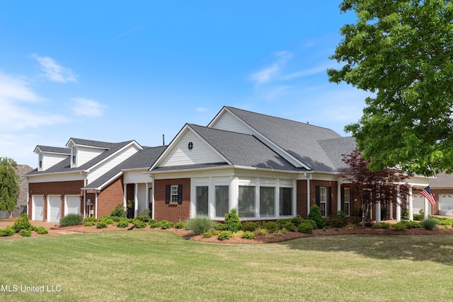 6507 Shenandoah Ln, Olive Branch, MS 38654 - view of front facade featuring a garage, a front yard, roof with shingles, and brick siding