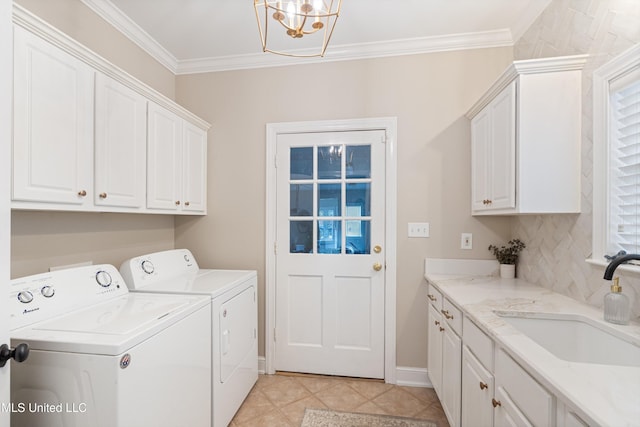 6507 Shenandoah Ln, Olive Branch, MS 38654 - laundry area with cabinet space, a sink, a chandelier, ornamental molding, and washer and clothes dryer