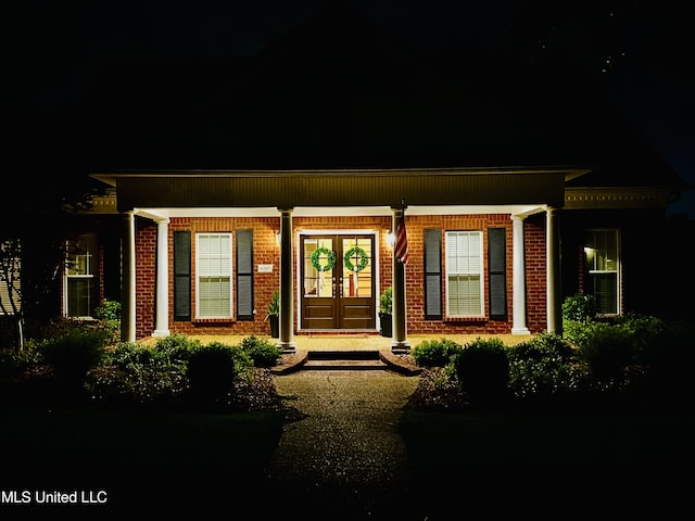 6507 Shenandoah Ln, Olive Branch, MS 38654 - doorway to property featuring covered porch, brick siding, and french doors