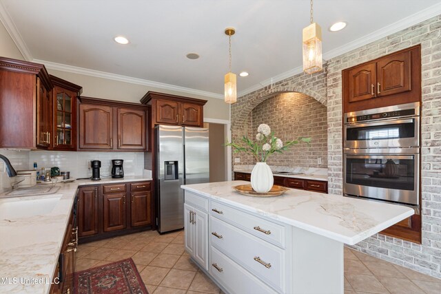 6507 Shenandoah Ln, Olive Branch, MS 38654 - kitchen with a sink, stainless steel appliances, decorative backsplash, light tile patterned floors, and glass insert cabinets