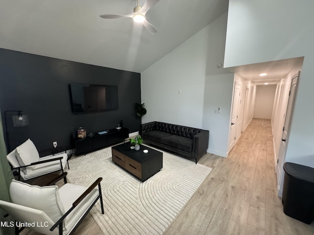 living room with light wood-type flooring, vaulted ceiling, and ceiling fan