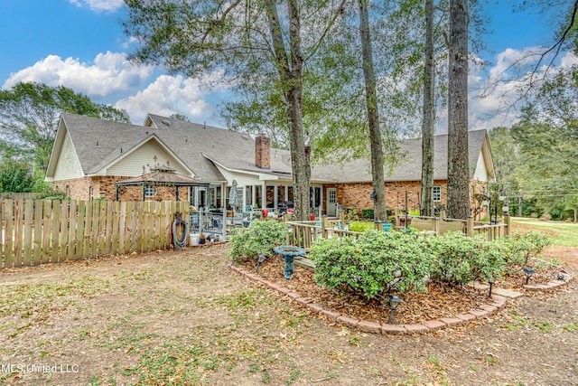 back of property featuring a gazebo