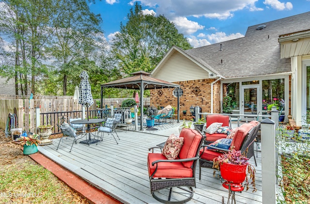 wooden deck featuring an outdoor living space and a gazebo